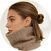 Profile of a woman with brown hair in a bun wearing a beige turtleneck sweater.