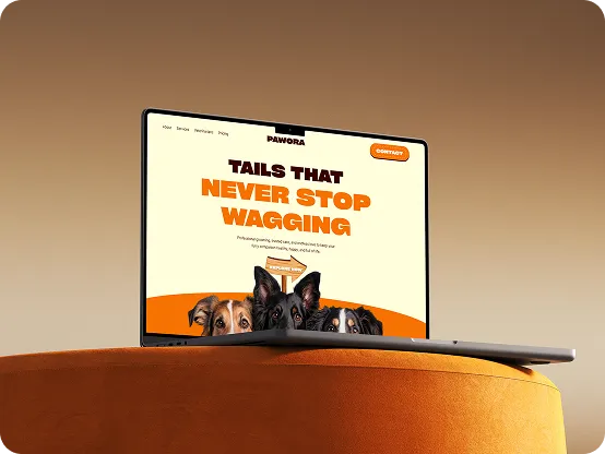 Laptop screen displaying a website with dogs and text: Tails that never stop wagging.