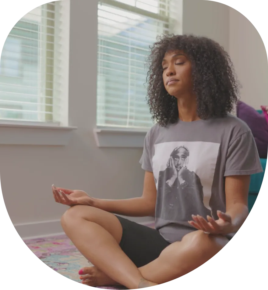 A woman sitting cross-legged in a calm moment