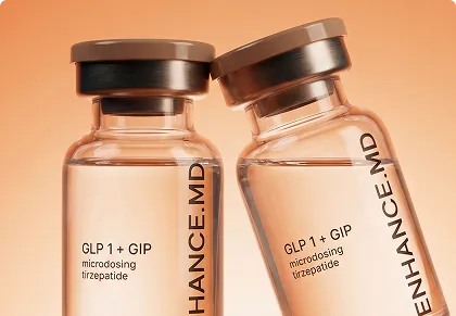 Two vials labeled GLP1+GIP microdosing tirzepatide from Enhance MD on an orange background.