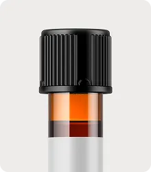 Close-up of a small amber glass vacuum tube with a black ridged cap on a white background.