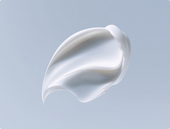 Creamy white smooth swirl of lotion against a soft blue background.