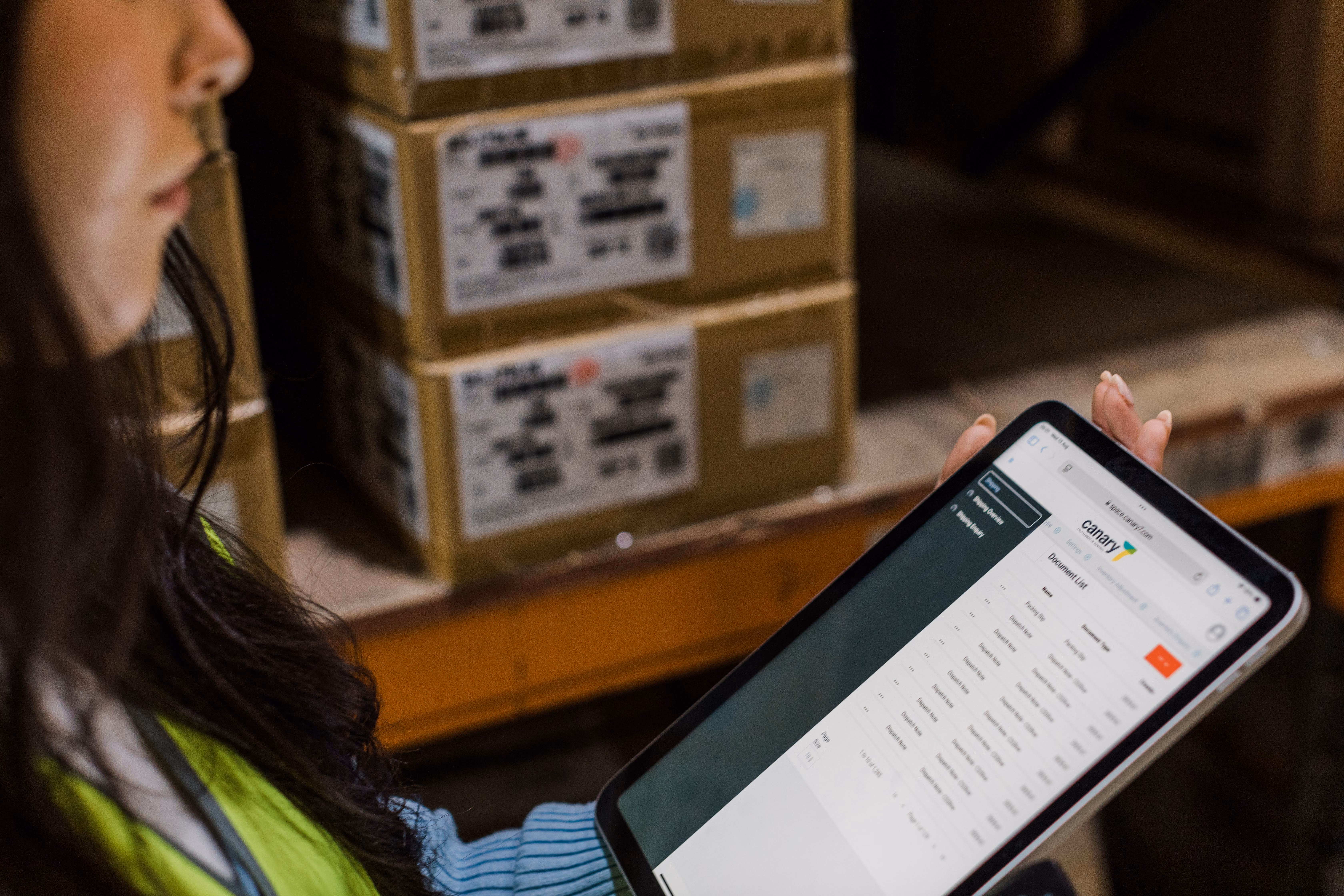 Warehouse worker using a tablet to manage warehouse operations