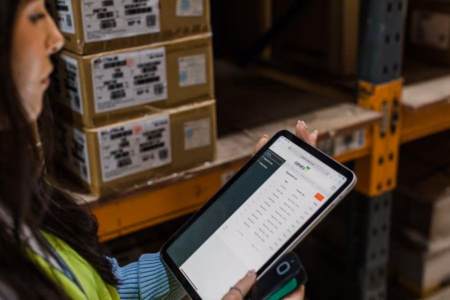 Warehouse worker using a tablet to check inventory and stock levels