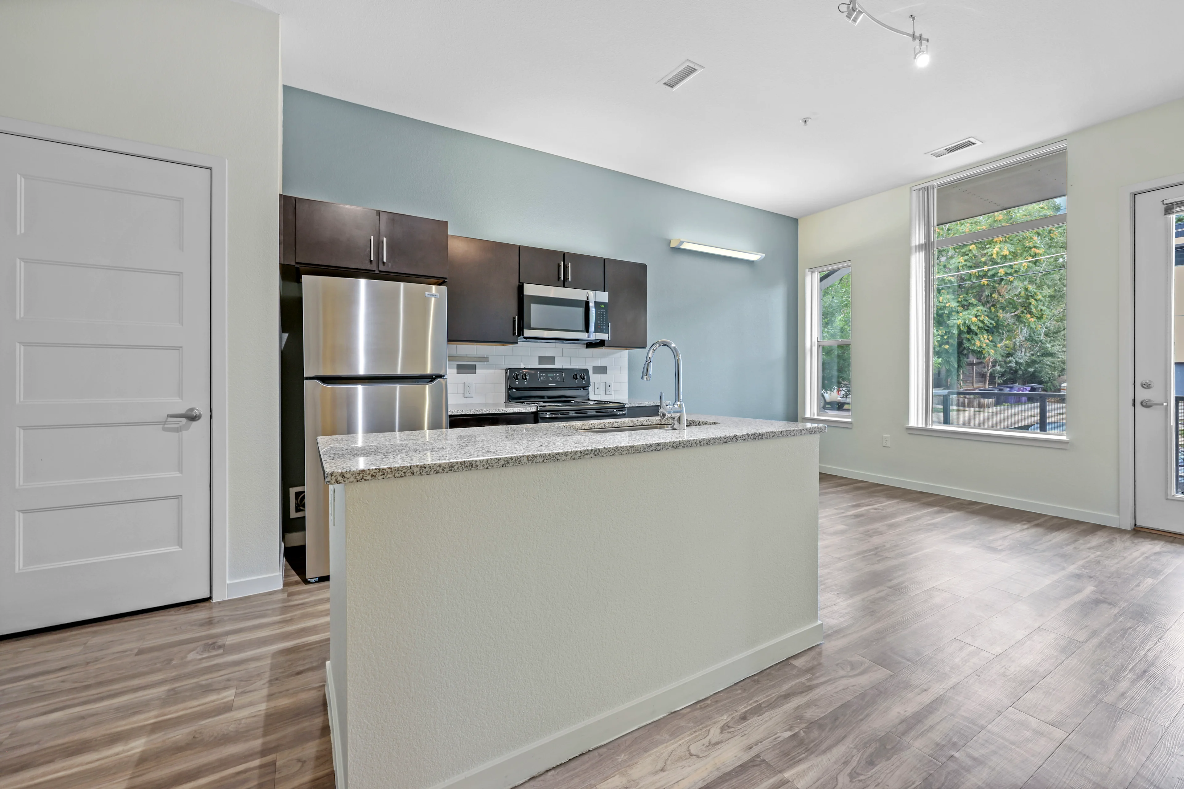 Kitchen with island and dark cabinets