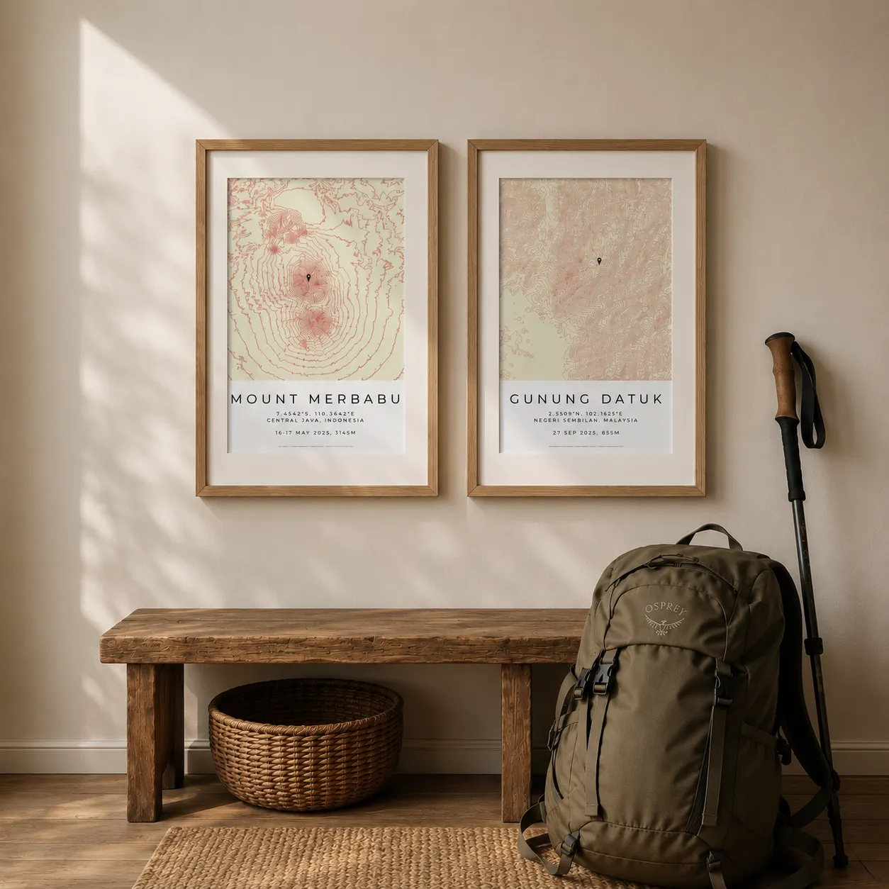 Two framed topographic maps titled Mount Merbabu and Gunung Datuk hang above a bench with a basket and hiking gear.