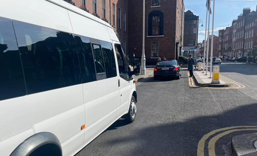White 16-seater minicoach from Dublin Minicoach Hire parked on a Dublin city street