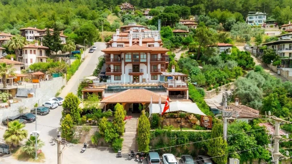 Aerial view of the Lotus Hotel in Akyaka, surrounded by gardens and village houses