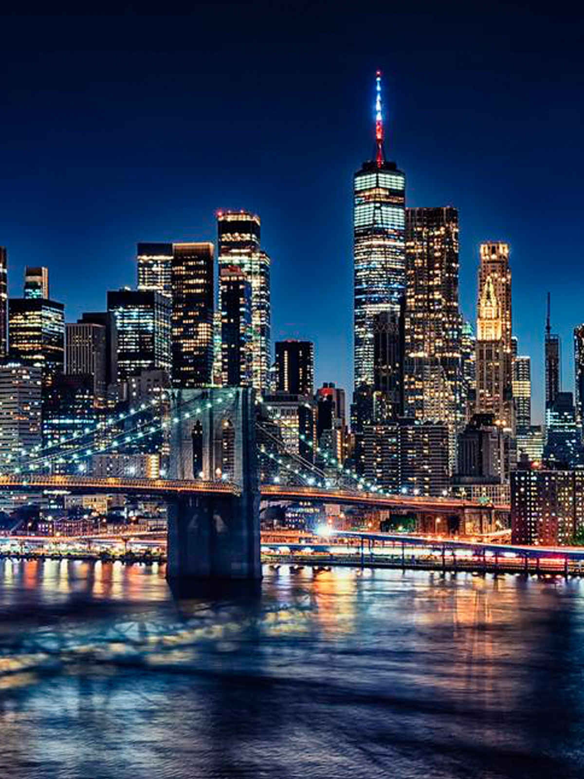 Manhattan skyline at night with the Brooklyn Bridge
