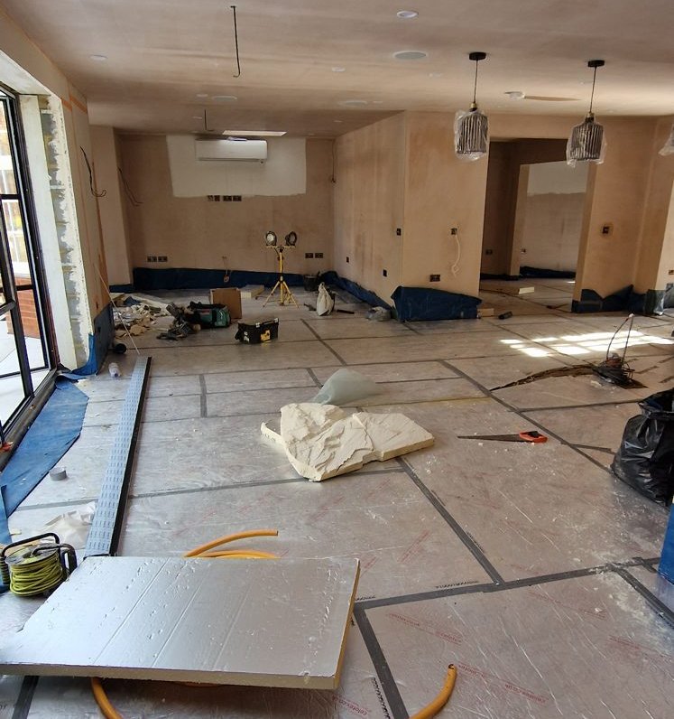 Silver insulation boards laid across the ground floor before the screed
