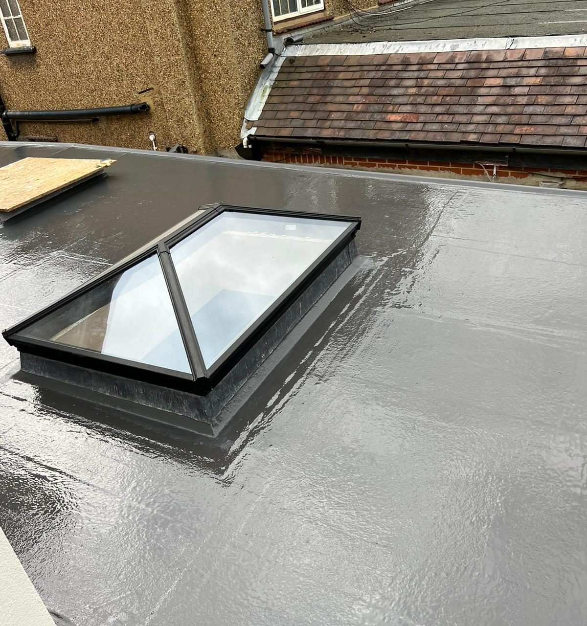 Finished grey fibreglass flat roof with a black-framed roof lantern