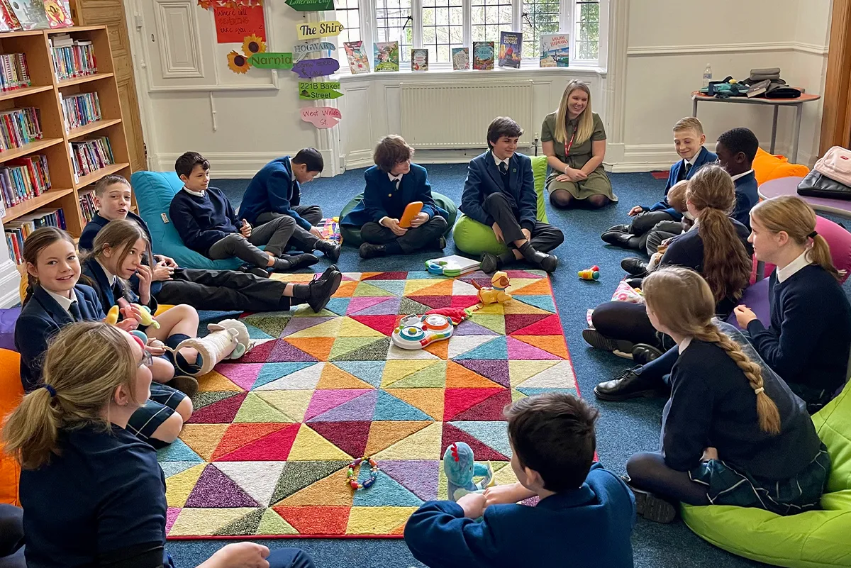 School children with baby in the circles for learning programme shaping understanding and regulation