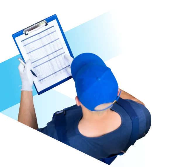 Person wearing a blue cap and gloves holding a clipboard with a checklist, viewed from above.