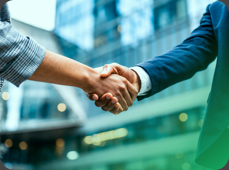 Business handshake in front of office buildings