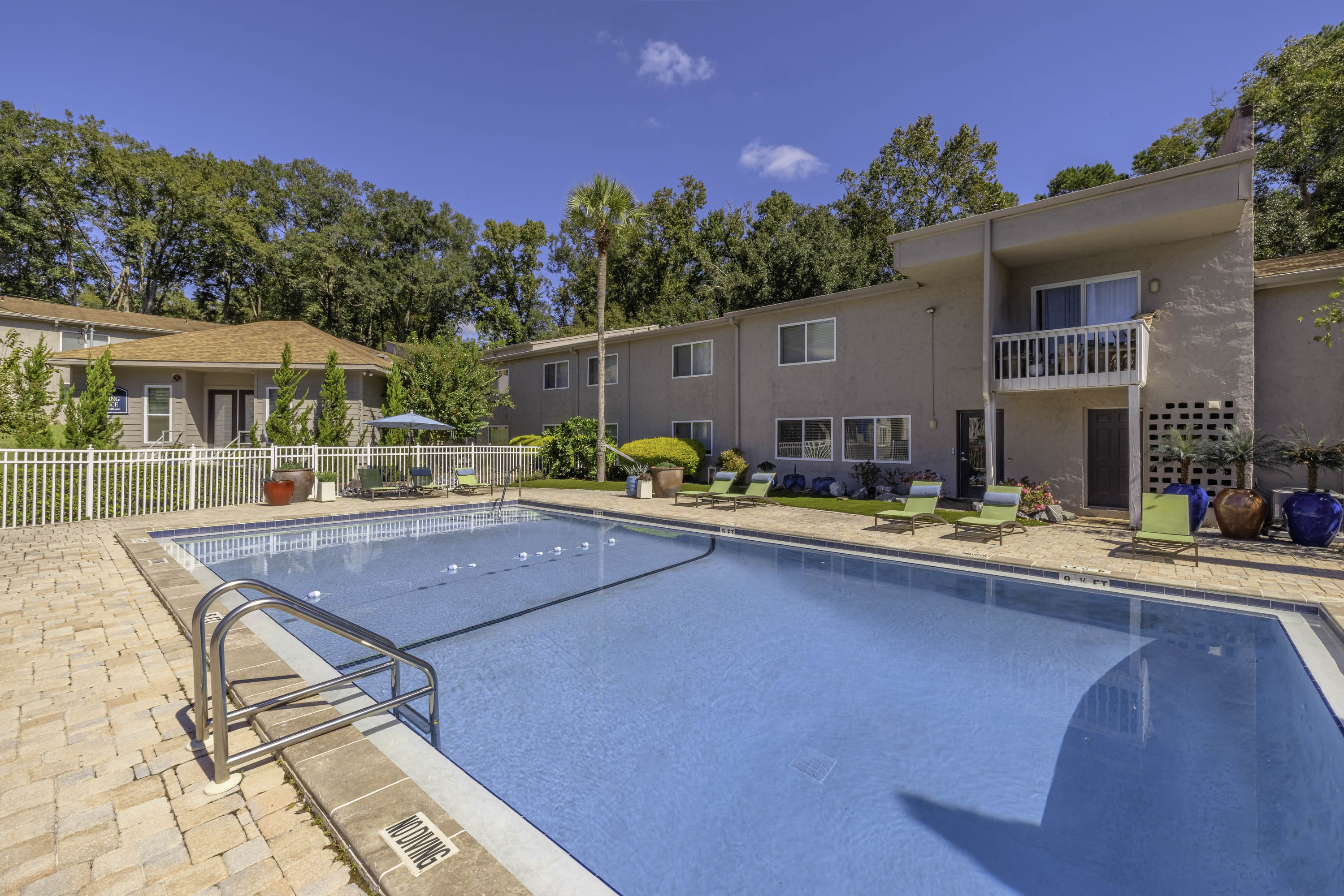 Pool with patio and furniture around