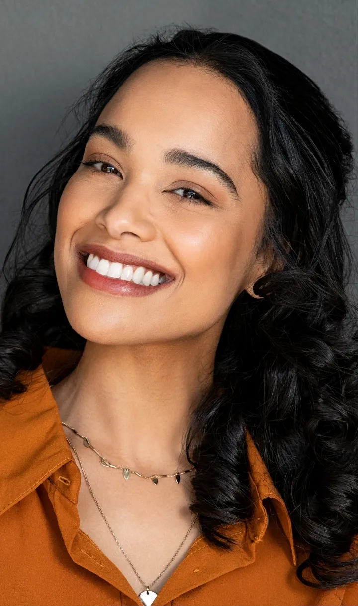 Woman with a bright smile after cosmetic dental treatment