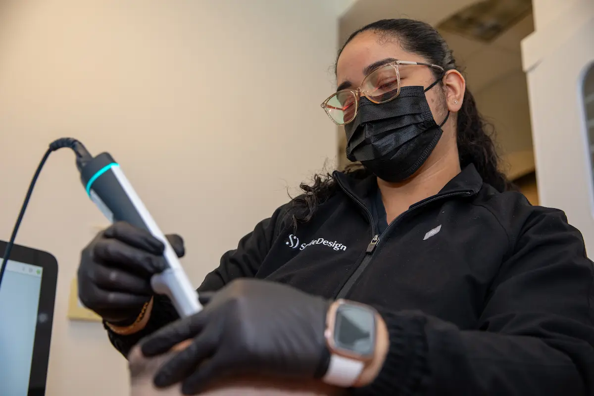 Dental assistant preparing a handpiece for a procedure