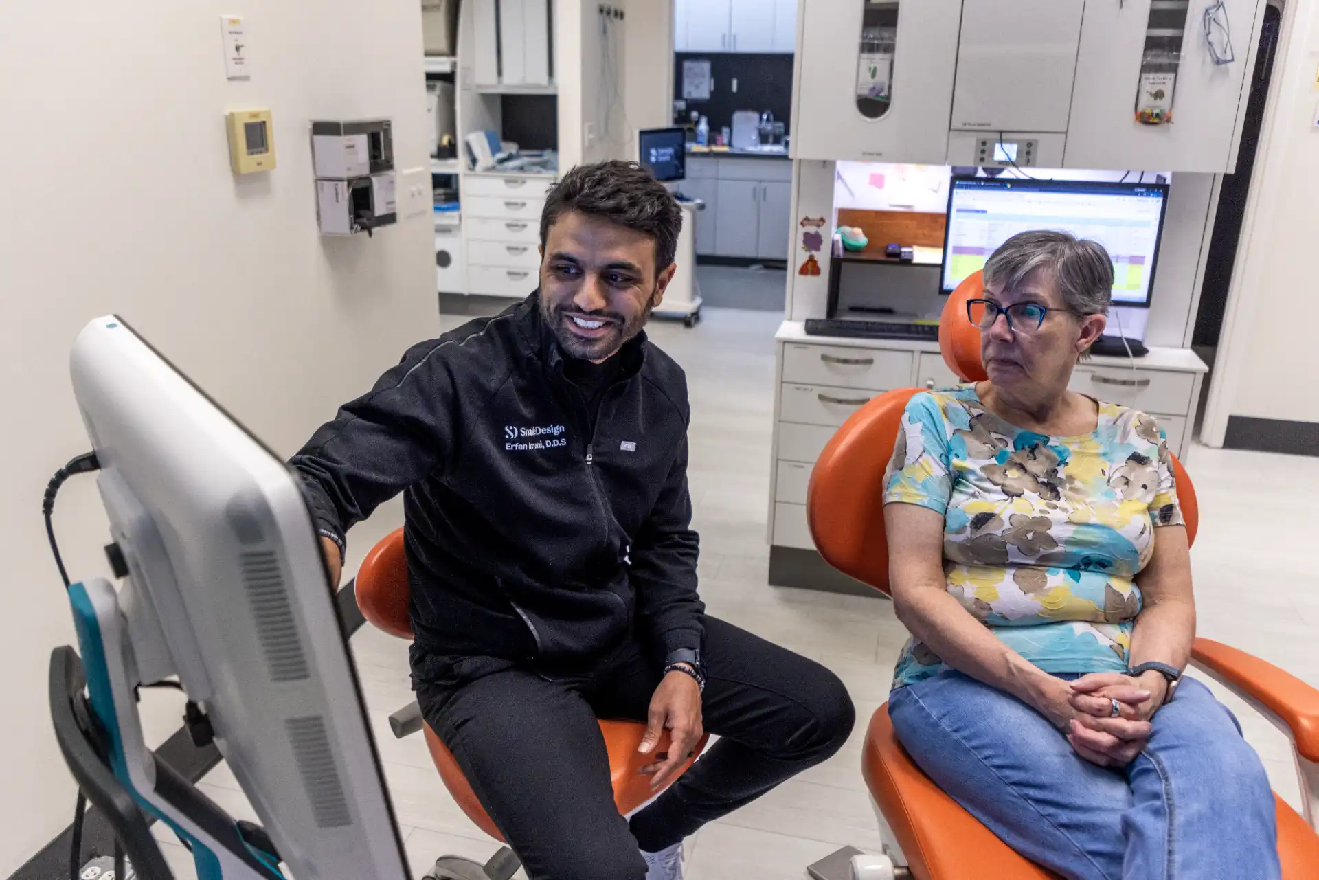 Dentist with a patient in a treatment room at Smile Design Modern Dentistry