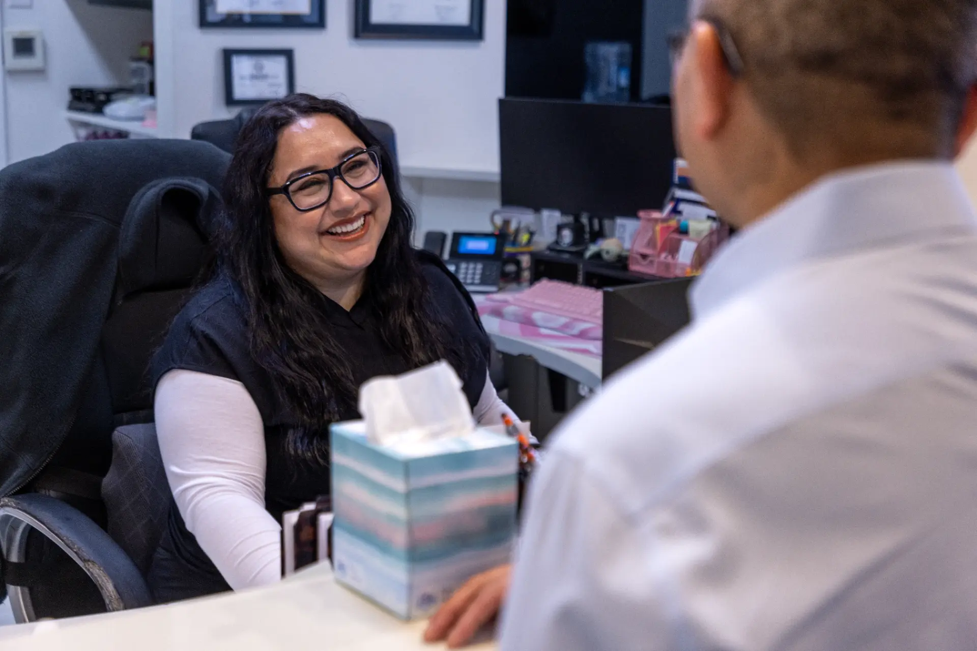 Smile Design Modern Dentistry team member greeting a patient at the reception desk