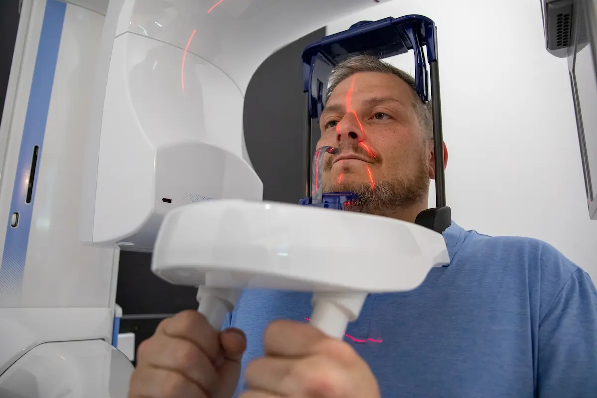 Patient having a digital panoramic jaw scan, the type of imaging used to plan dental implant placement
