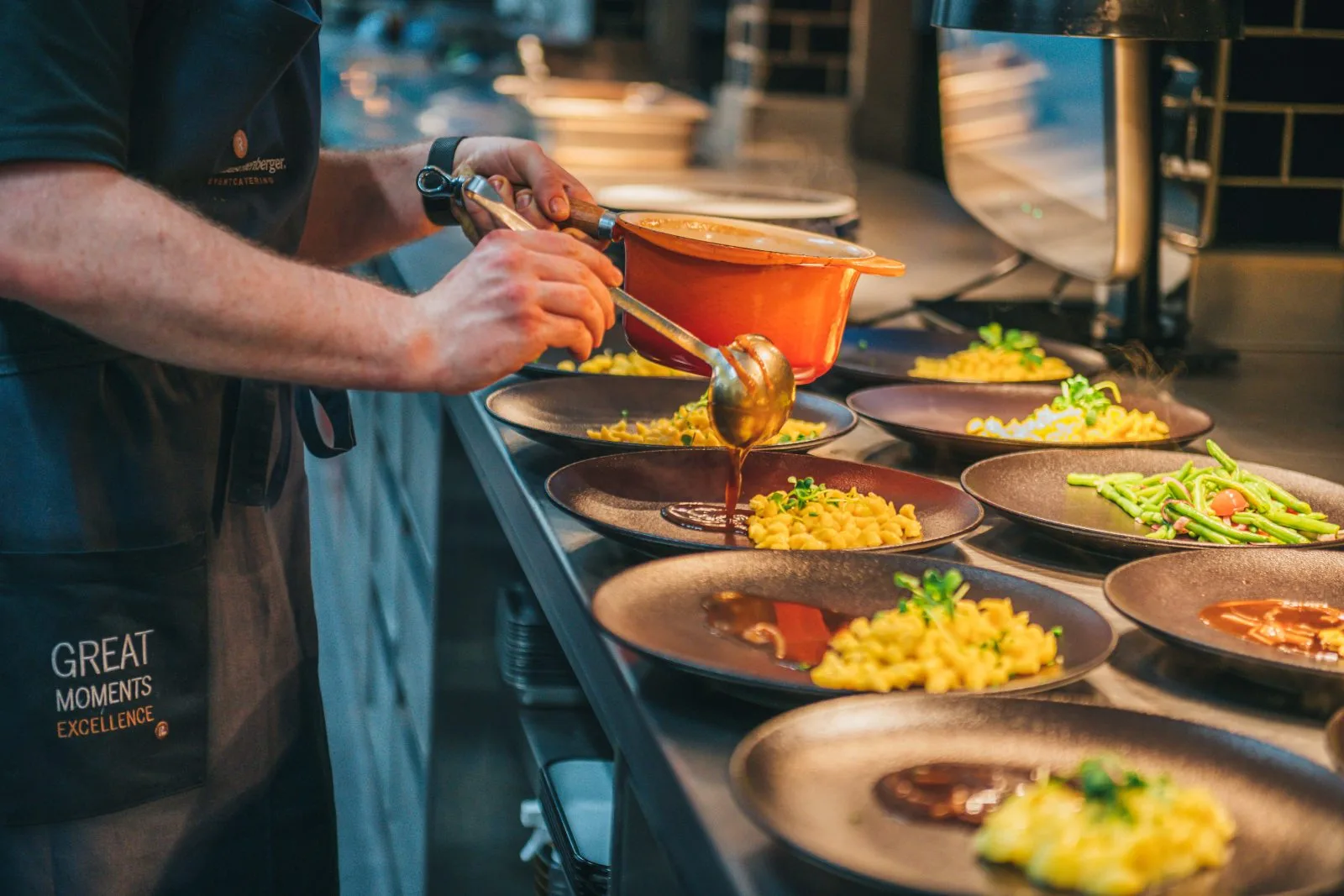 Kitchen team plating the menu