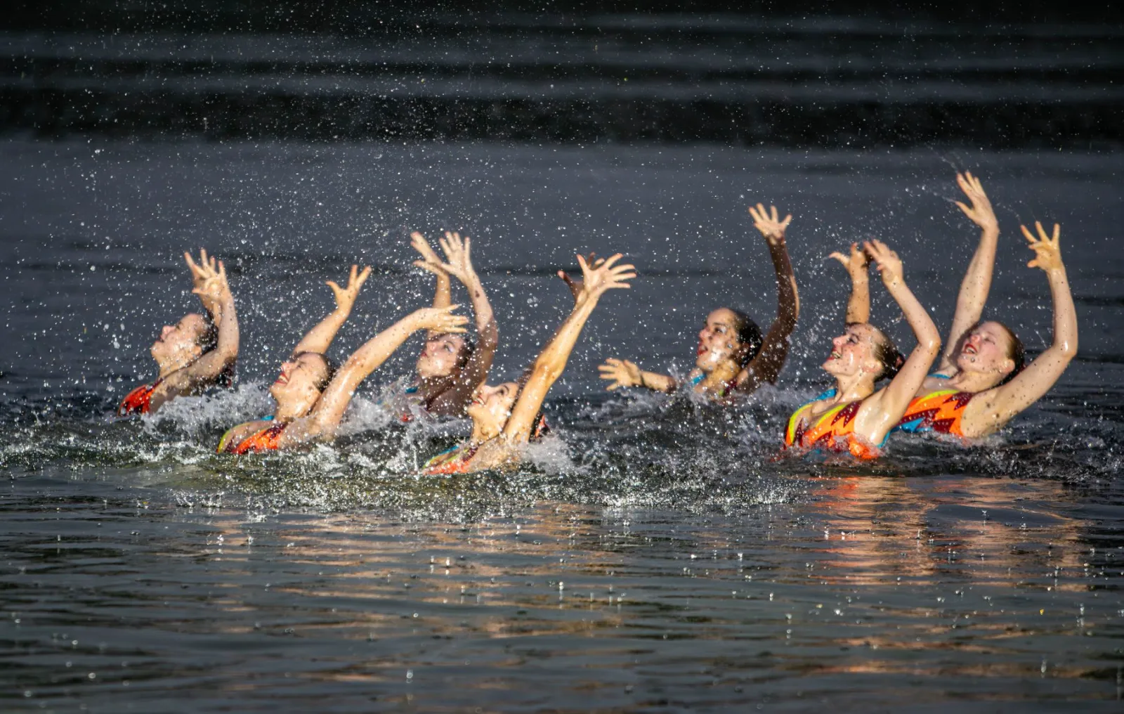 Synchronised swimmers emerging from the lake at a trade fair side event