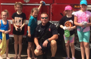 Kids washing a Rockwall fire rig at a charity event
