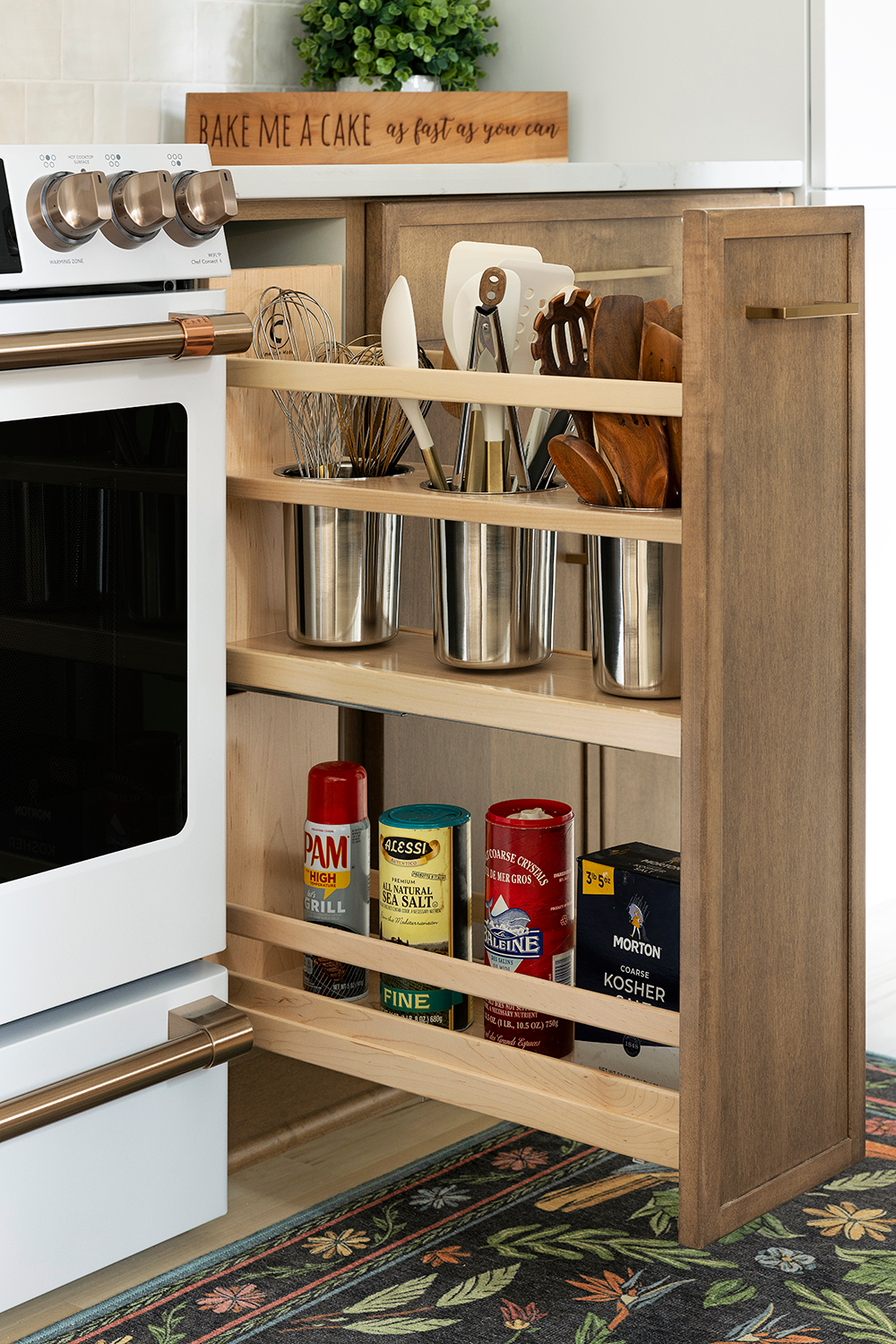 Pull-out spice rack in white oak beside the range
