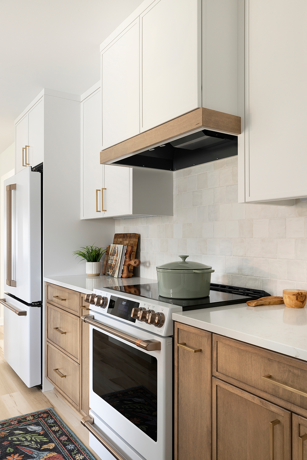 Range below a white oak vent hood shelf