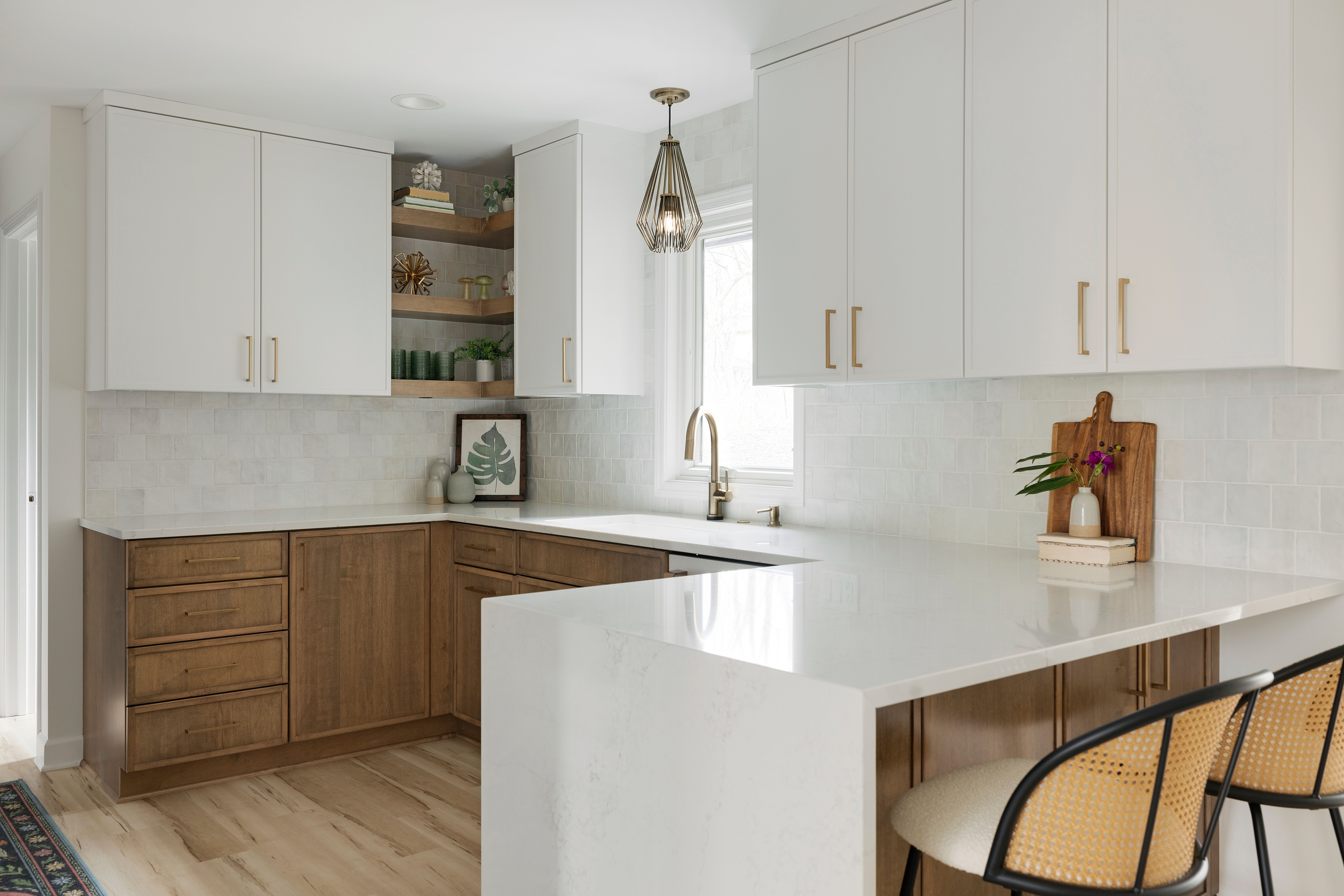 Peninsula with cane-back stools and a glass-front upper cabinet