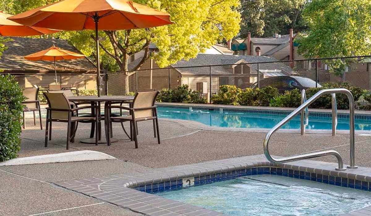 Pool with patio table and a umbrella