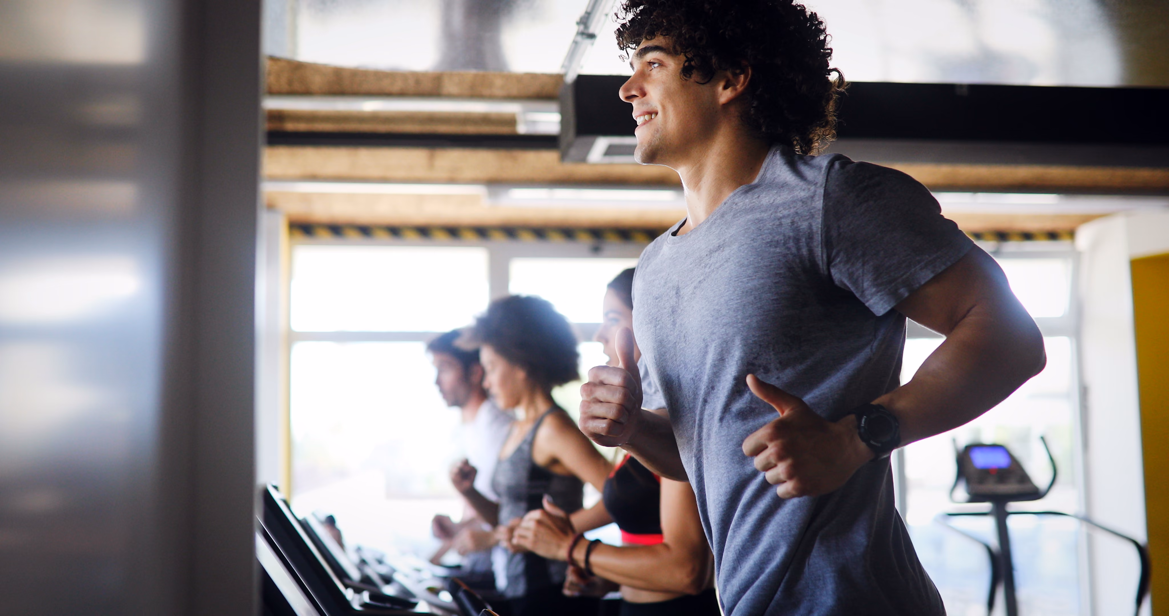 People running on treadmill stock image