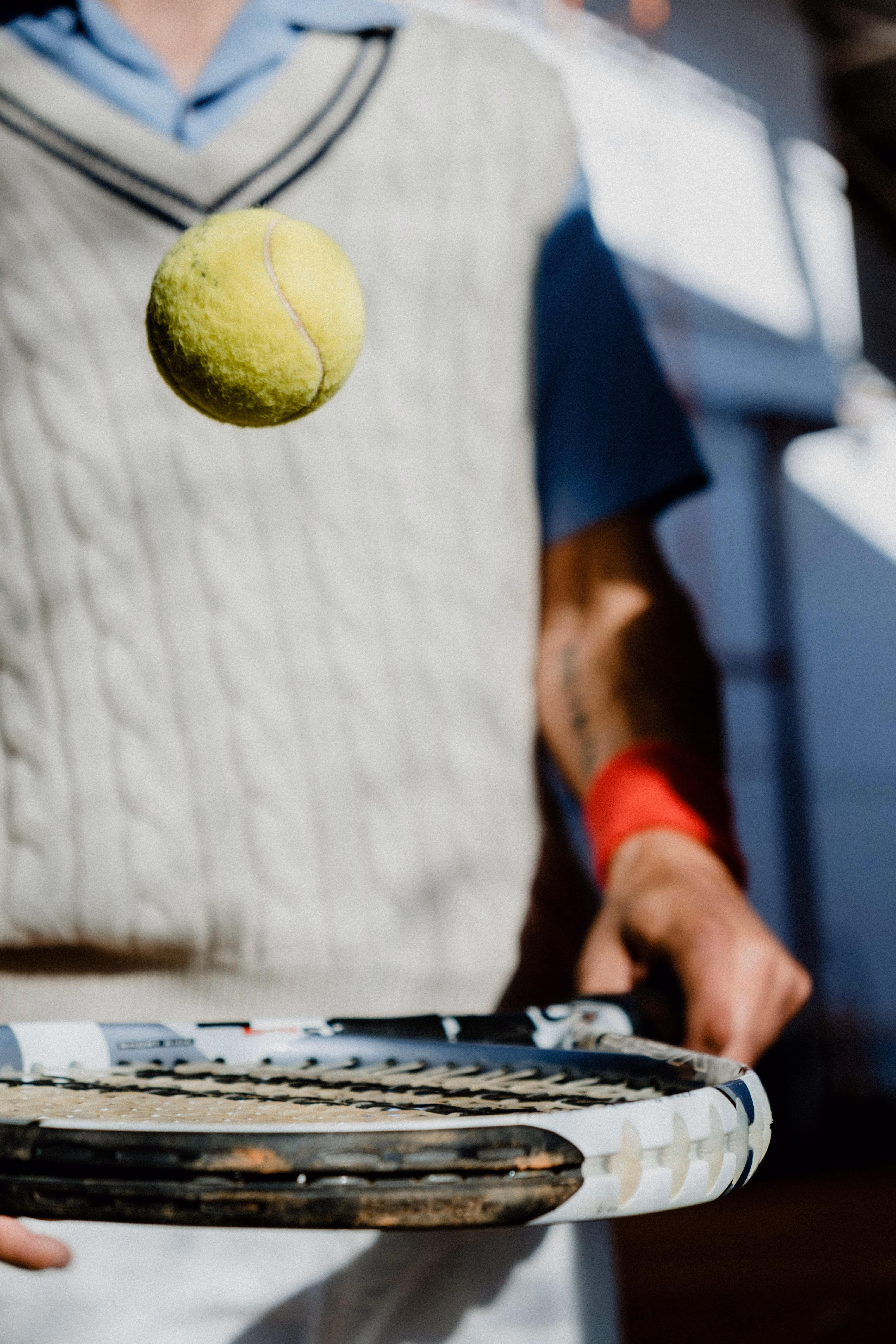 Person bouncing tennis ball on racket stock image