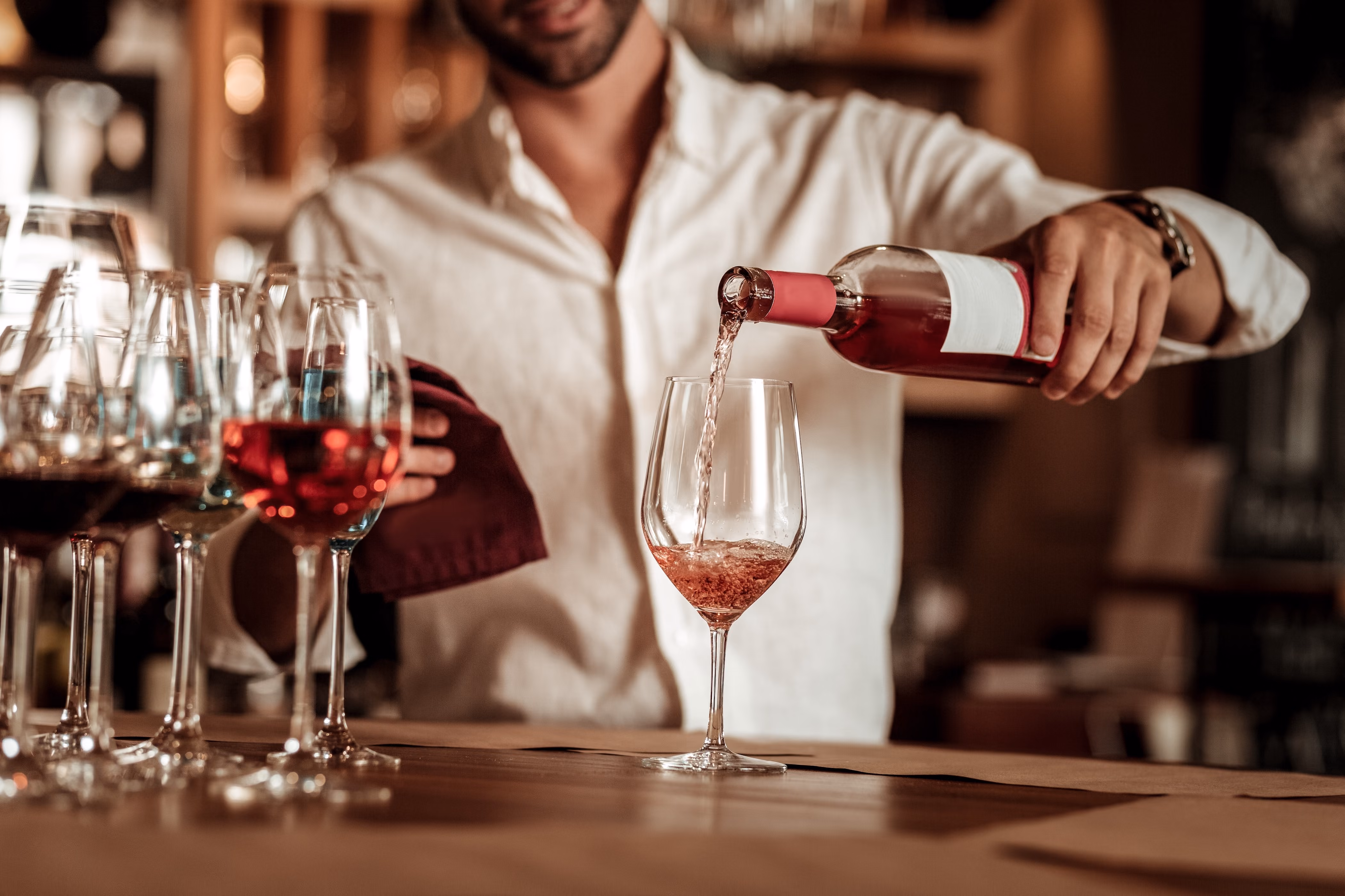 Man pouring wine in glass stock image