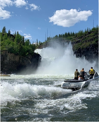 Ali-Craft Boat near waterfall on rushing river