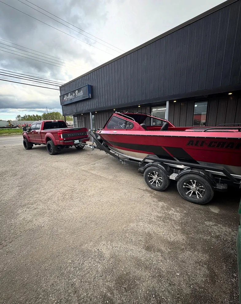 Ali-Craft Boats ranger boat being towed by truck