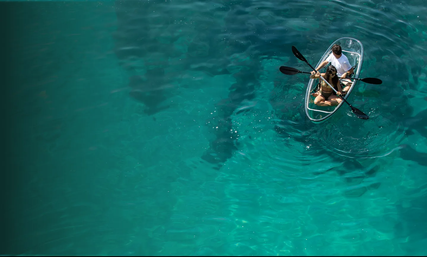 Turquoise water in Arrábida with a transparent kayak