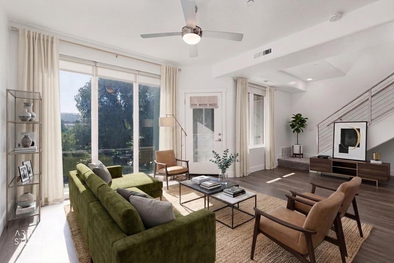 Living area with chair and view into bedroom