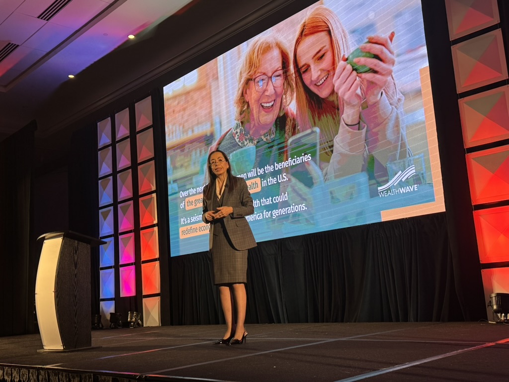Speaker addressing the WealthWave convention audience