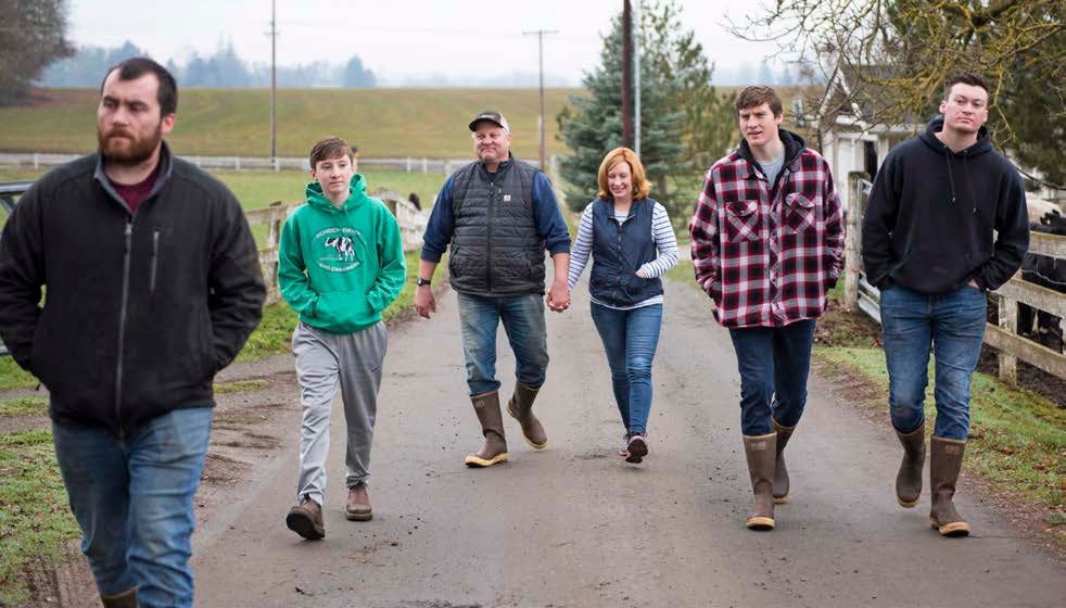 Dave and Casey Schoch walking the farm lane with their four sons