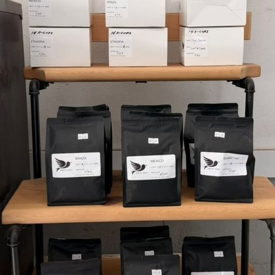 Bags and single-serve pods of Robin's Roast coffee, roasted weekly by hand