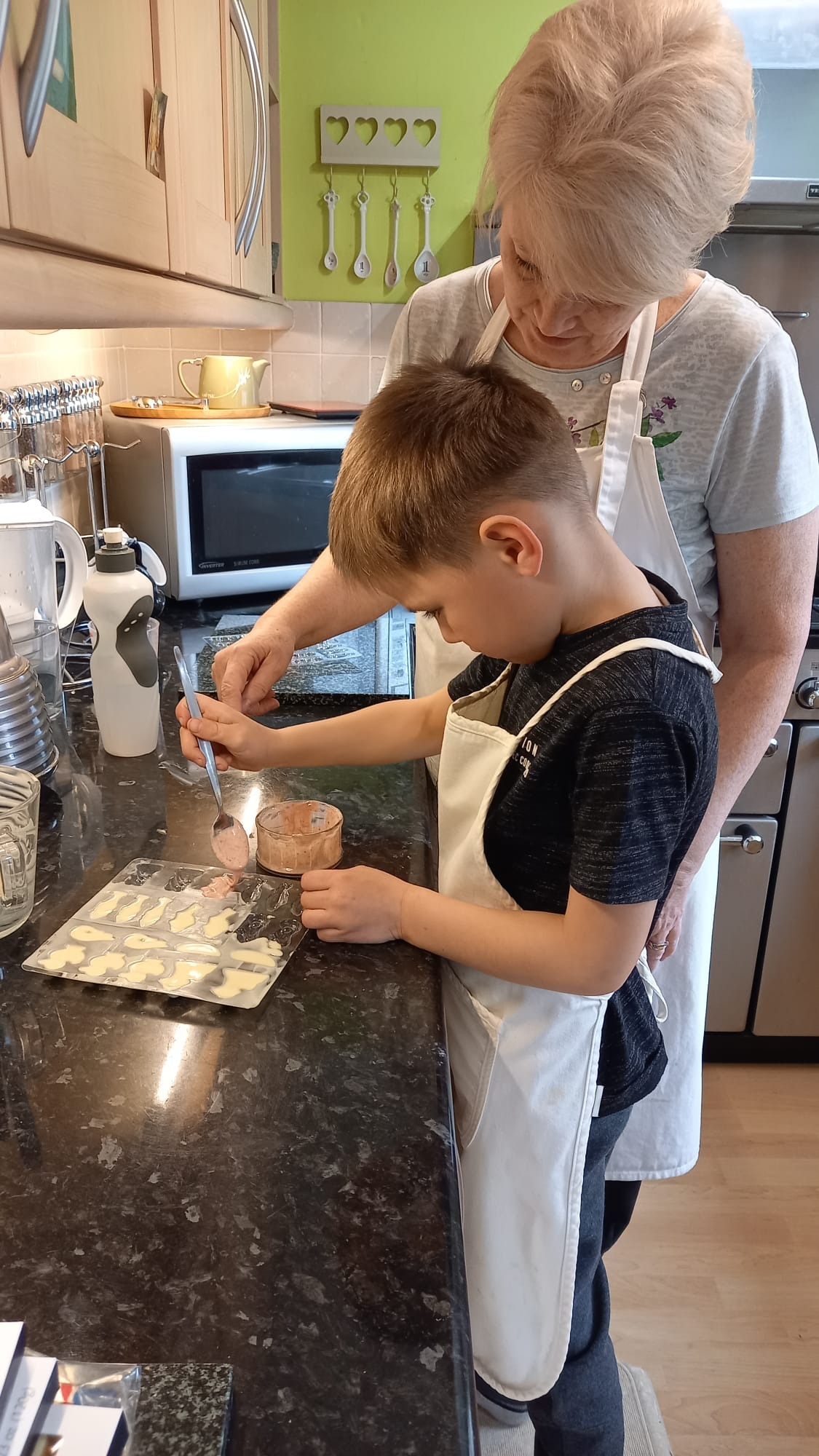 Linda baking at home with a young helper
