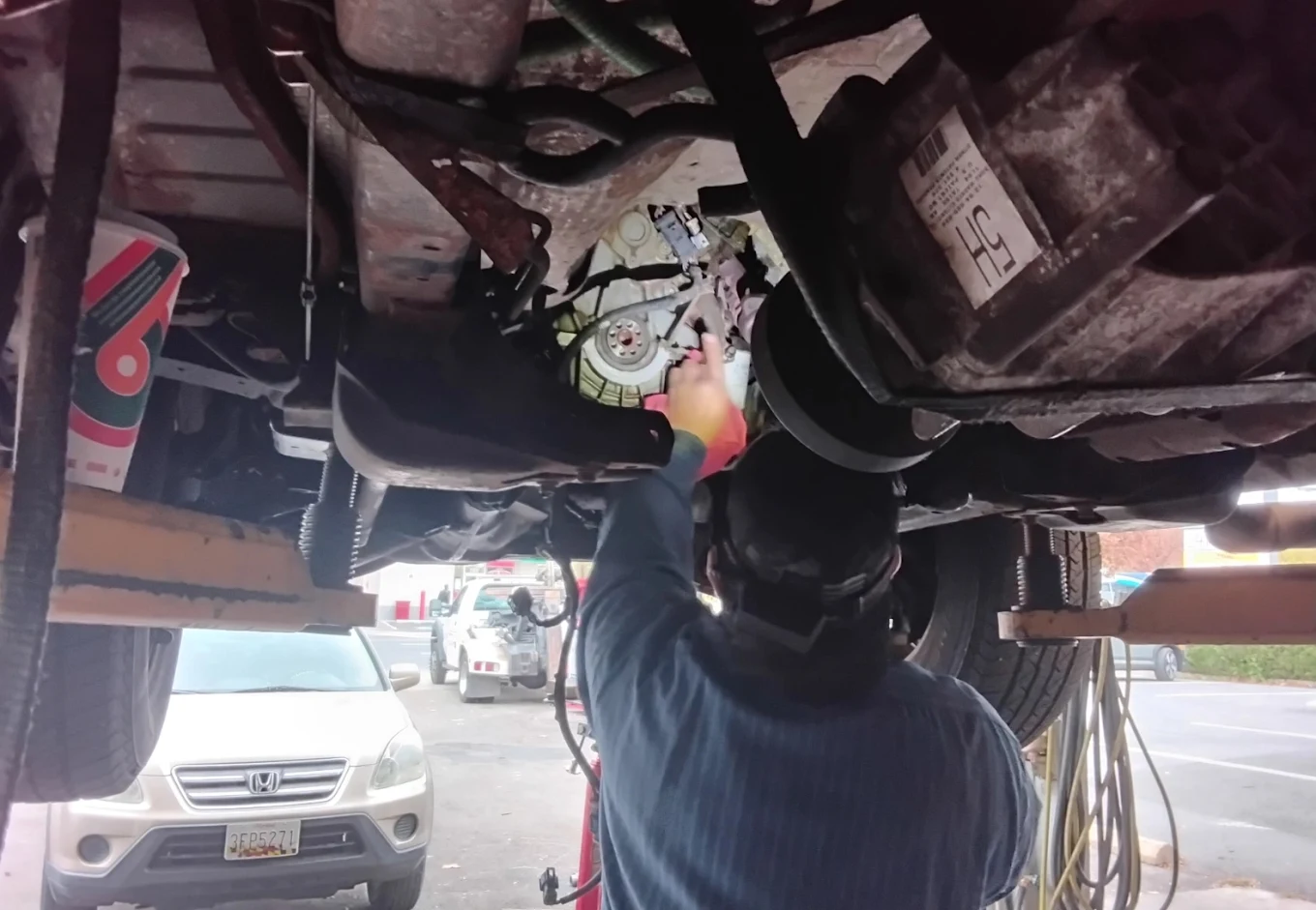 Technician servicing a vehicle at Joe's Auto Repair in Silver Spring
