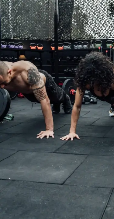 **Alt text:** Group of athletes performing push-ups during a CrossFit class at a fitness gym in Bakersfield, CA.