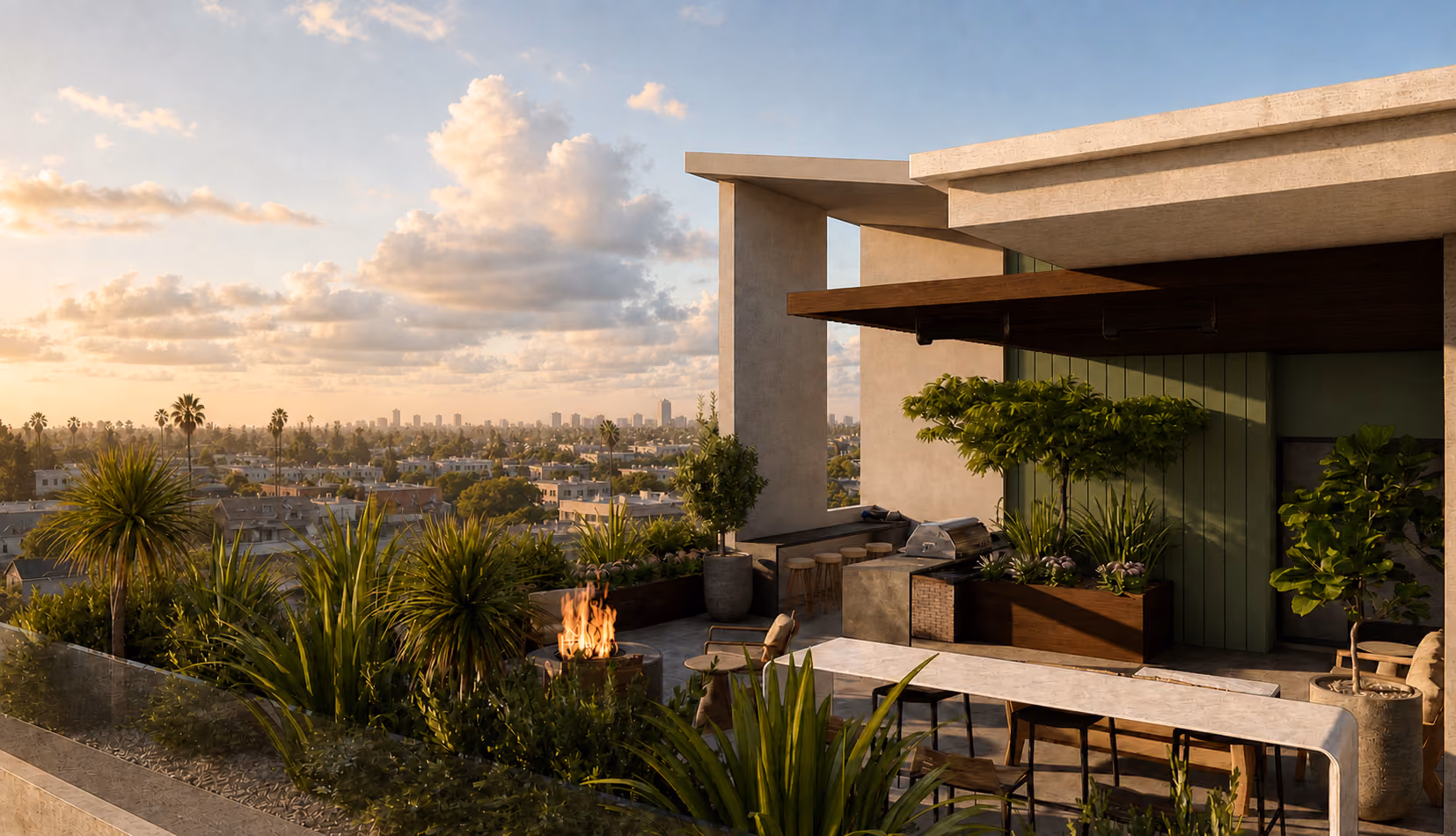 Rooftop patio with plants, fire pit, seating, and city skyline at sunset under a partly cloudy sky.