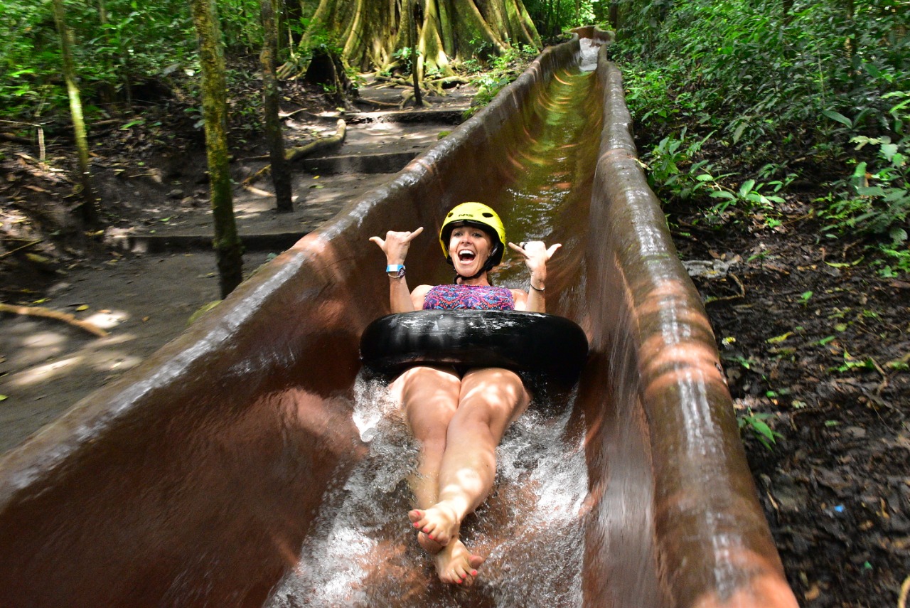 Water tubing down a jungle slide