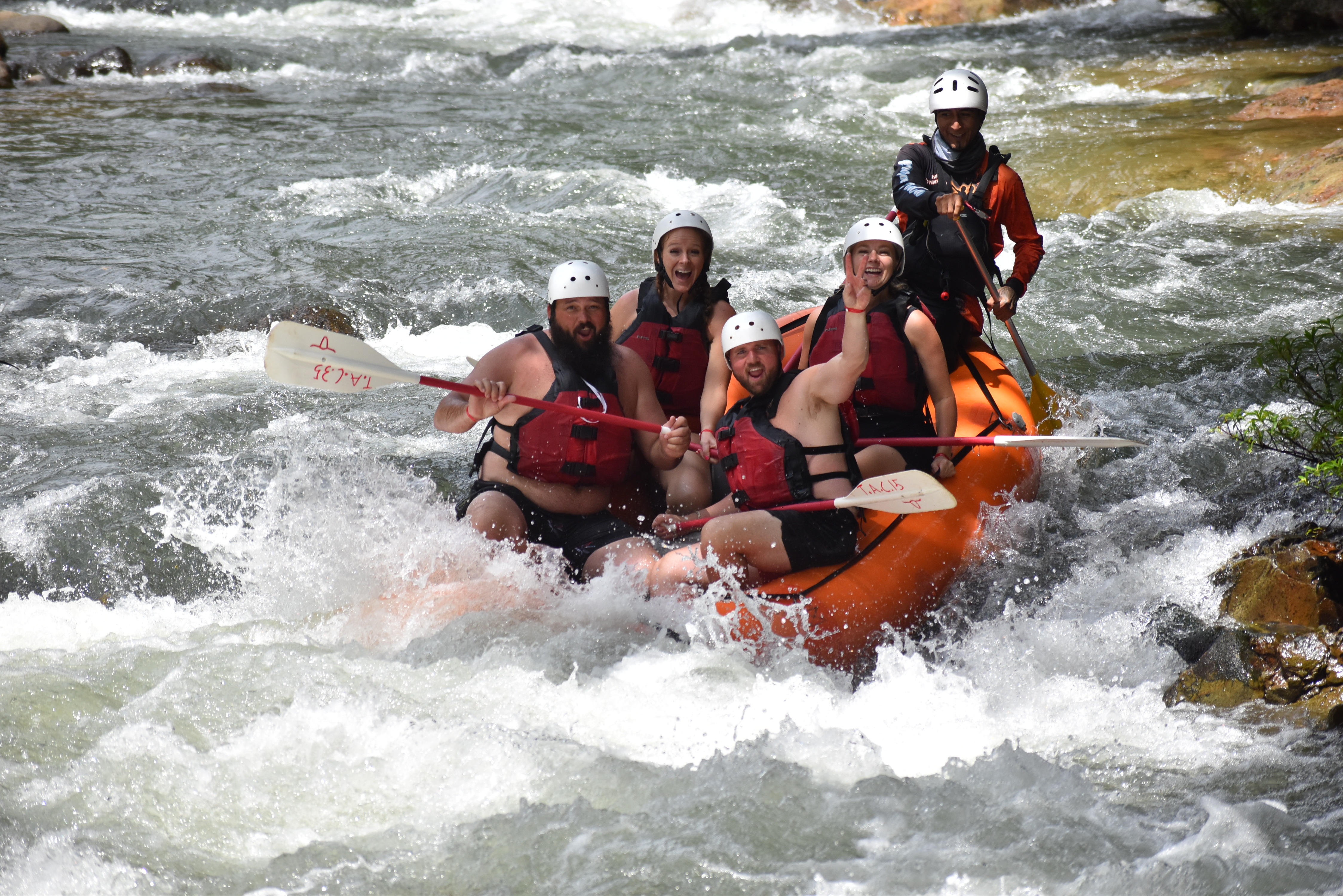Whitewater rafting group navigating rapids