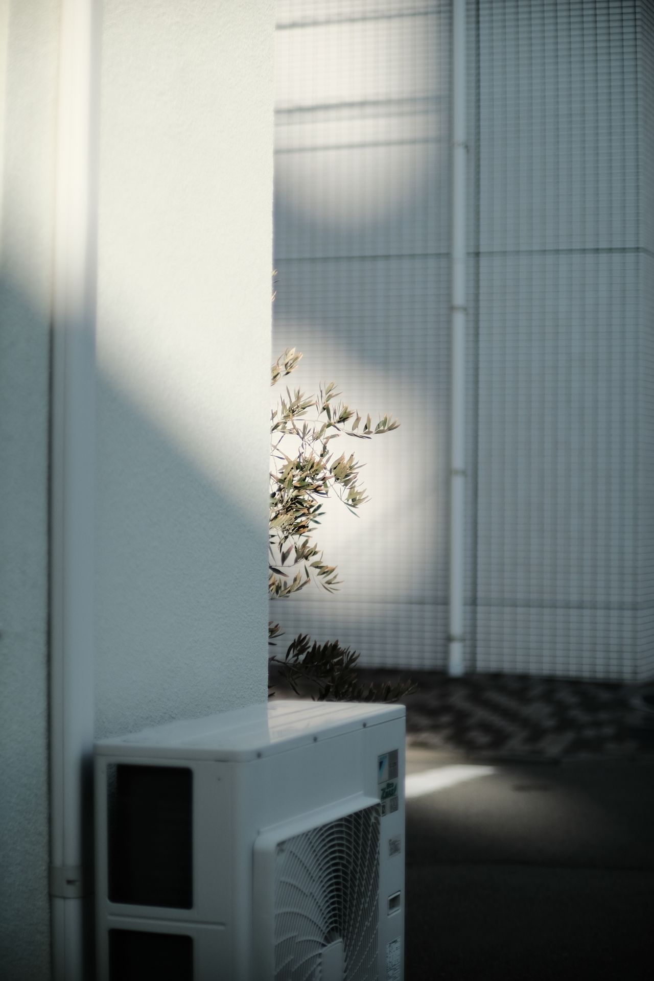 A contemporary air conditioning unit installed on a wall, representing the AC coil cleaning add-on