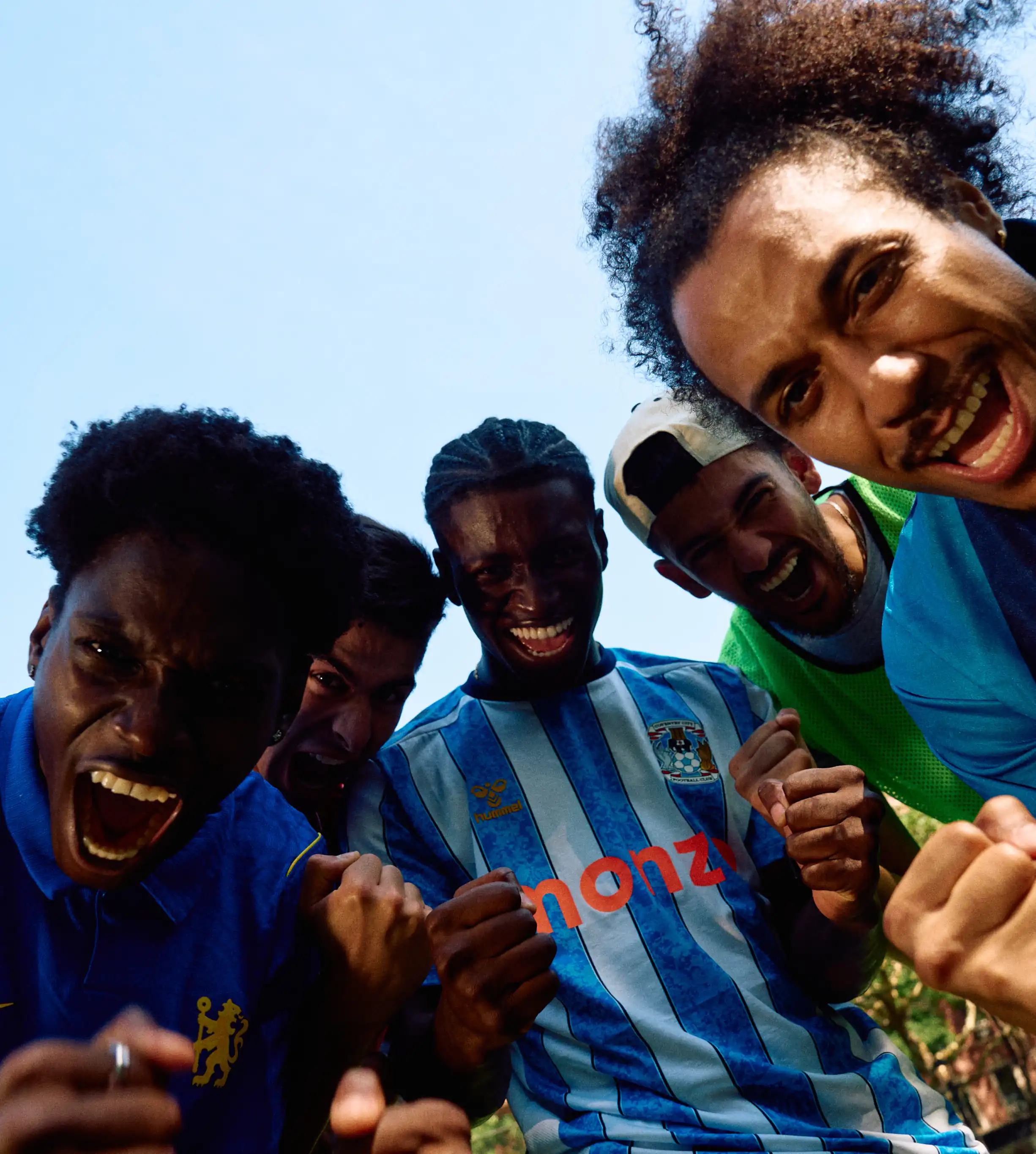 Group of football fans celebrating.
