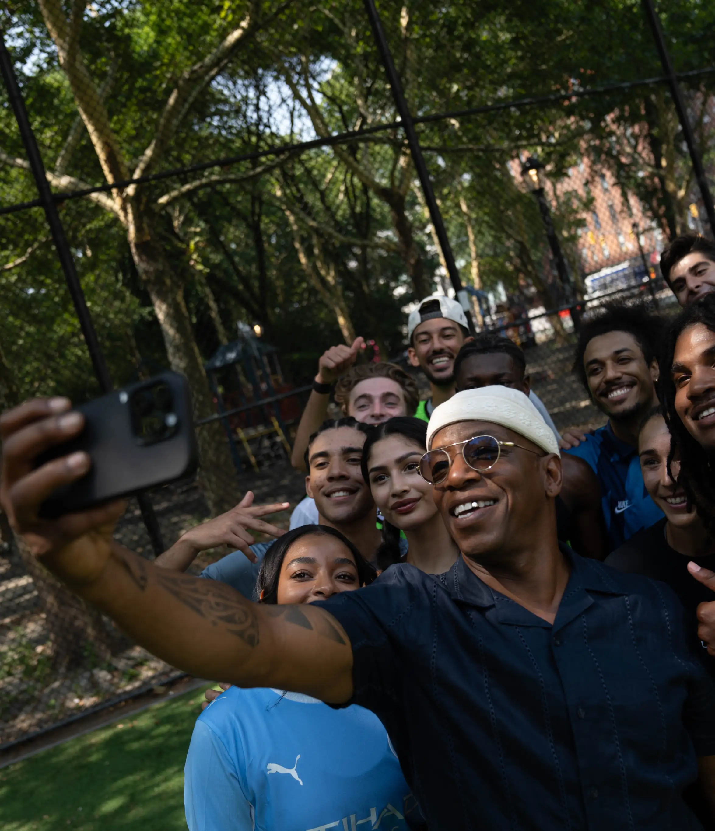 Ian Wright taking a group selfie with fans.